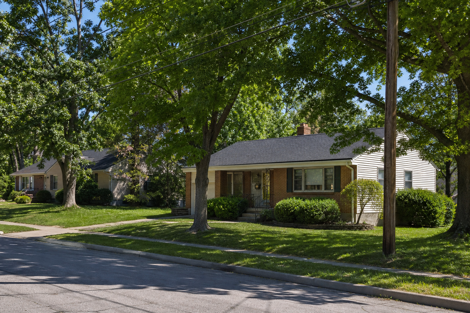 Photorealistic, non-identifiable brick ranch residence on an established Warrensburg street.