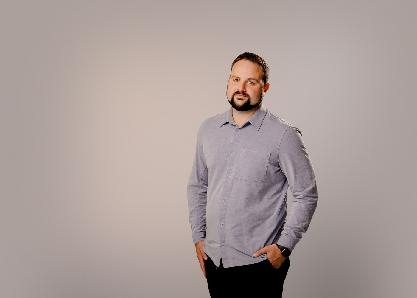 Austin Moore standing against a neutral studio background
